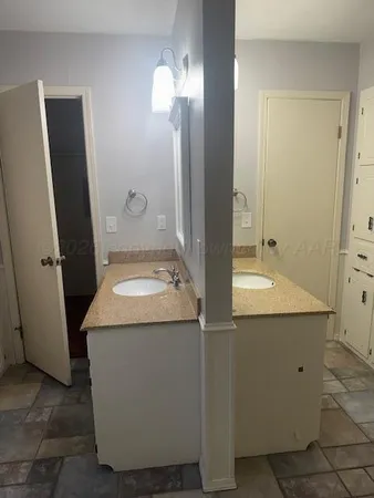 an empty room with mirror and shower