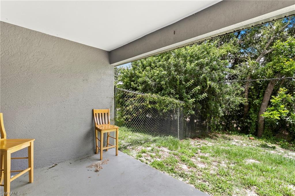 8264-8268 Matanzas Road Fort Myers, FL 33967 - Photo 26 of 33 a bench sitting in a yard next to a building