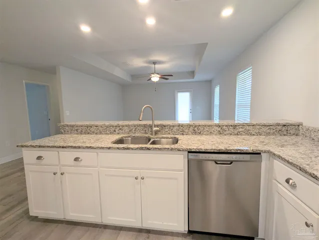 a bathroom with a granite countertop sink a toilet and a mirror