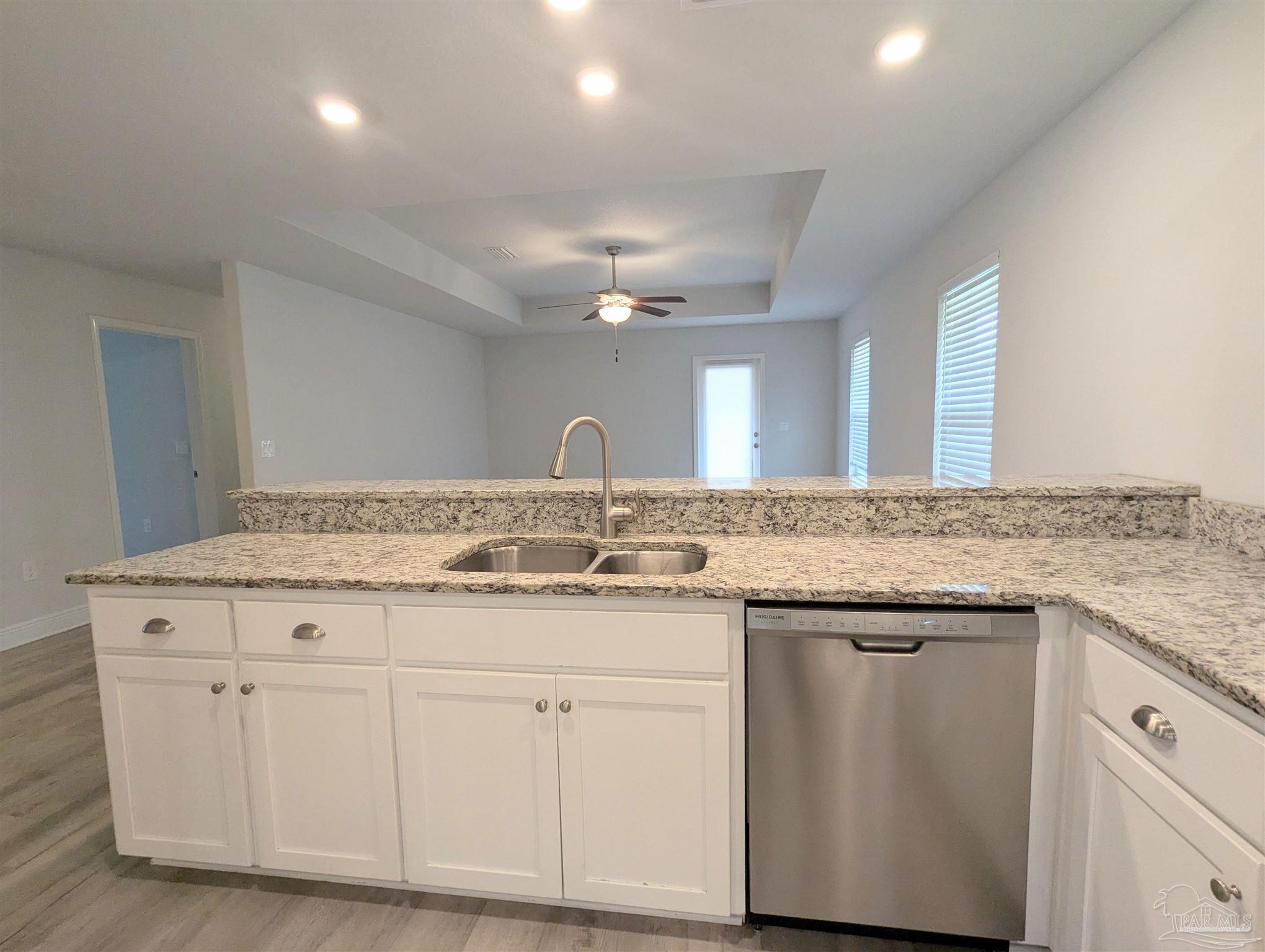 4723 Frances Street Pace, FL 32571 - Photo 14 of 41 a bathroom with a granite countertop sink a toilet and a mirror