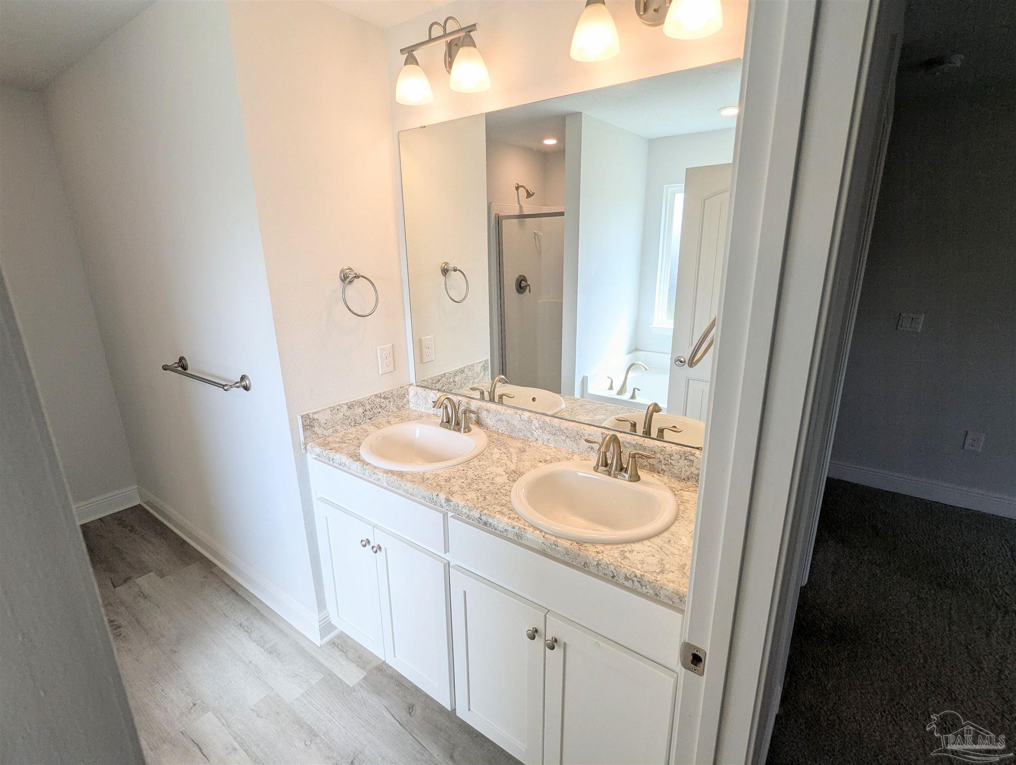4723 Frances Street Pace, FL 32571 - Photo 20 of 41 a bathroom with a granite countertop sink and a mirror