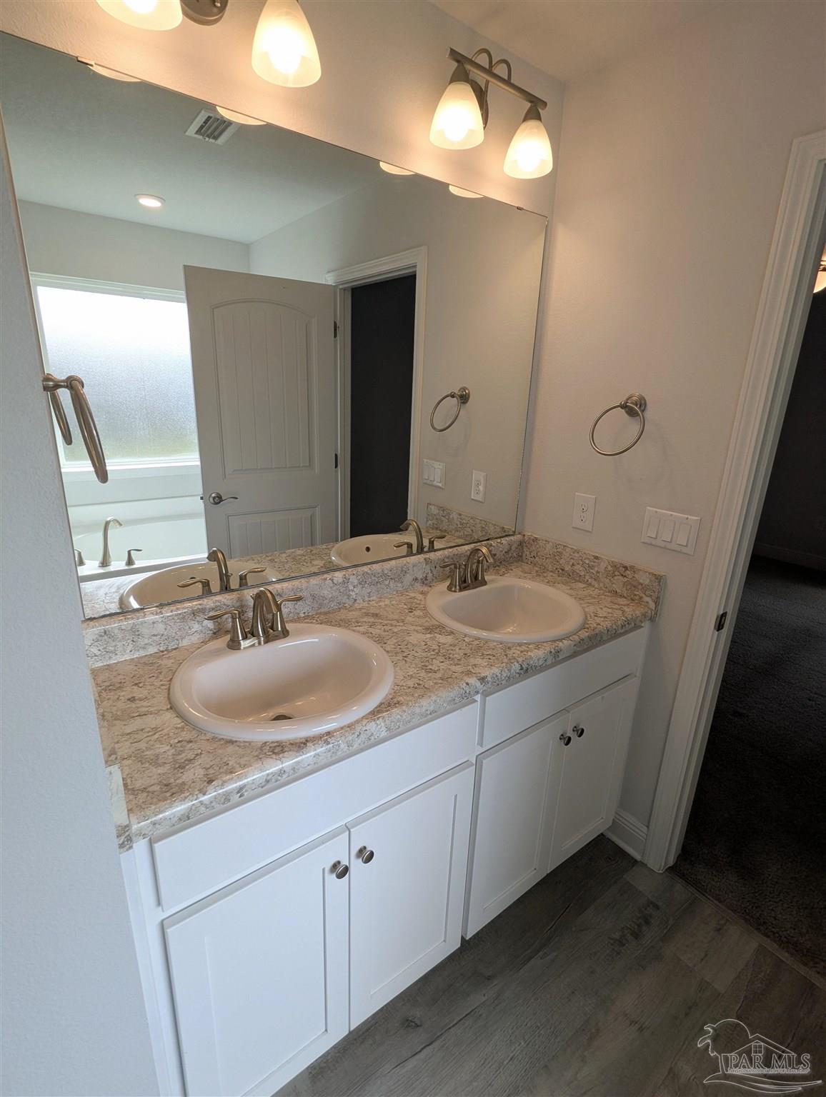 4723 Frances Street Pace, FL 32571 - Photo 21 of 41 a bathroom with a sink and a mirror