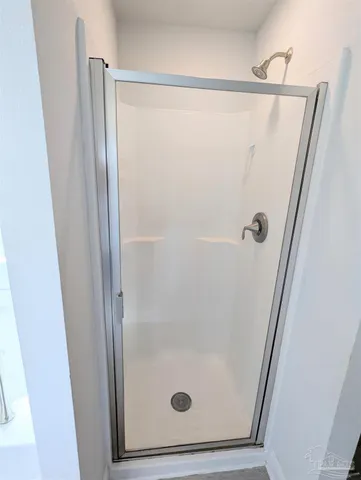 a bathroom with a glass shower door