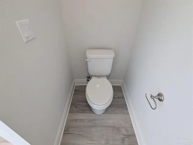 a bathroom with a toilet and a rug