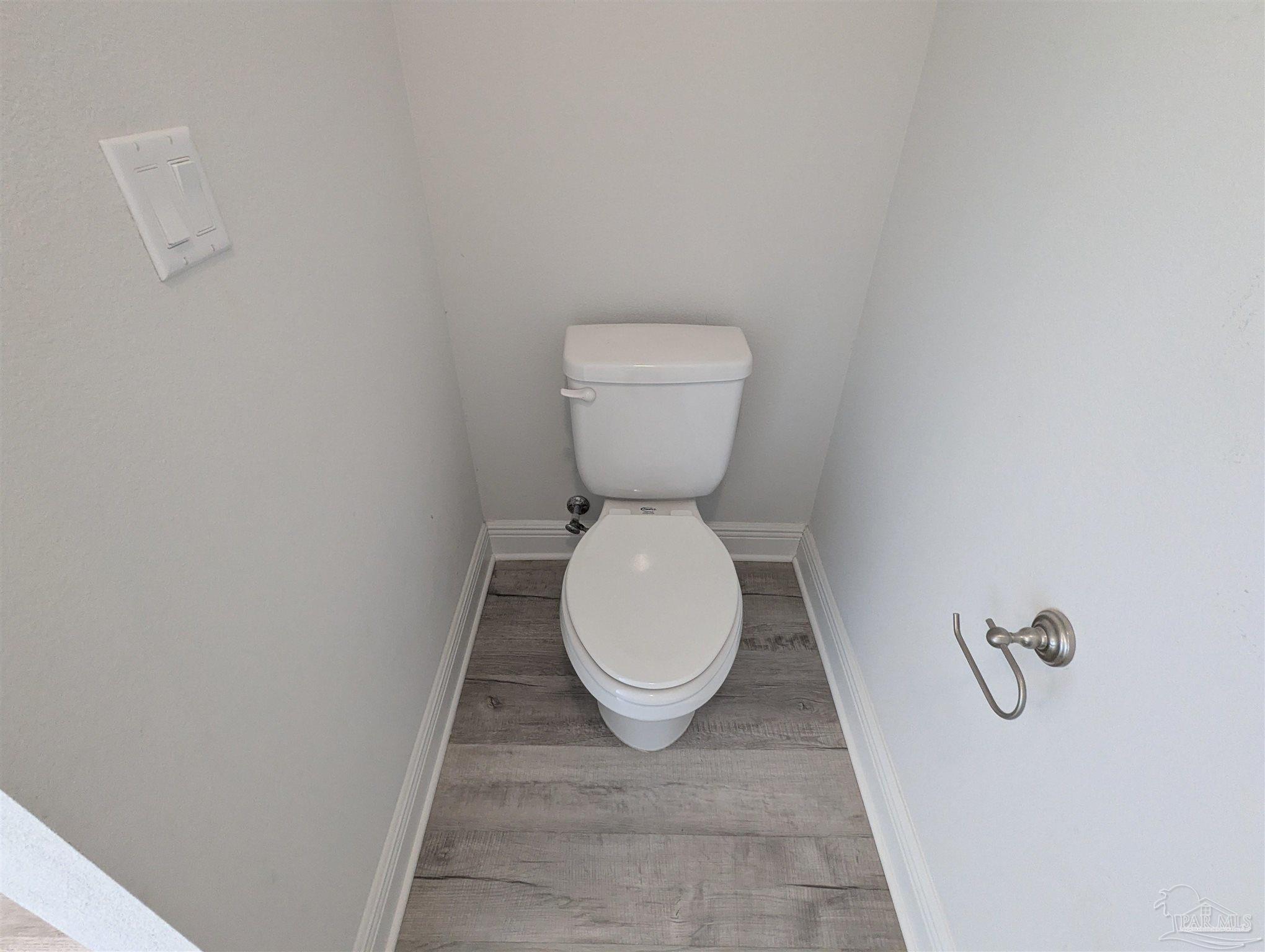 4723 Frances Street Pace, FL 32571 - Photo 24 of 41 a bathroom with a toilet and a rug