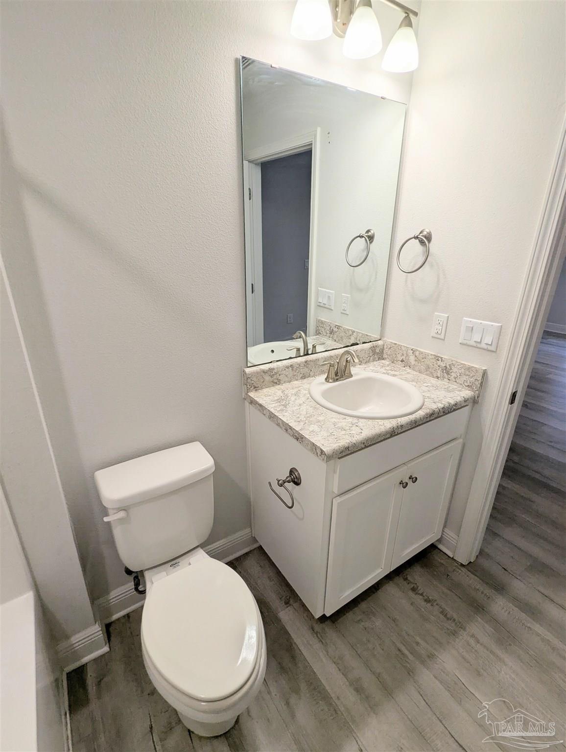 4723 Frances Street Pace, FL 32571 - Photo 33 of 41 a spacious bathroom with a granite countertop toilet sink and mirror