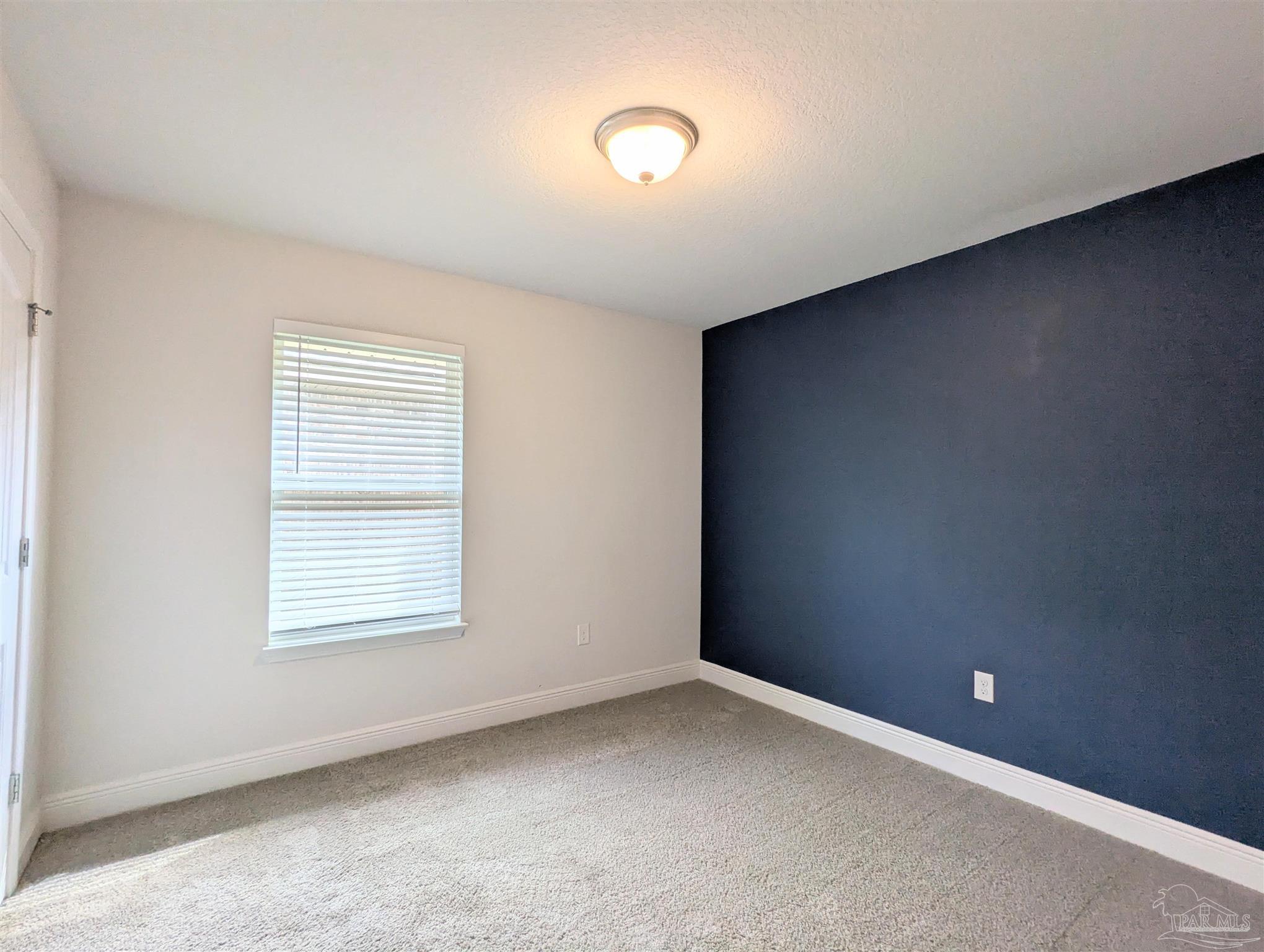 4723 Frances Street Pace, FL 32571 - Photo 35 of 41 an empty room with windows