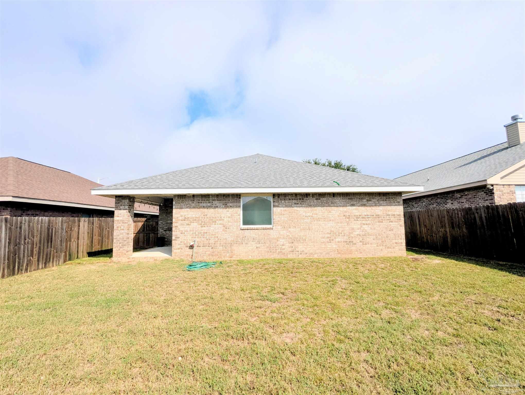 4723 Frances Street Pace, FL 32571 - Photo 40 of 41 a view of a house with a yard