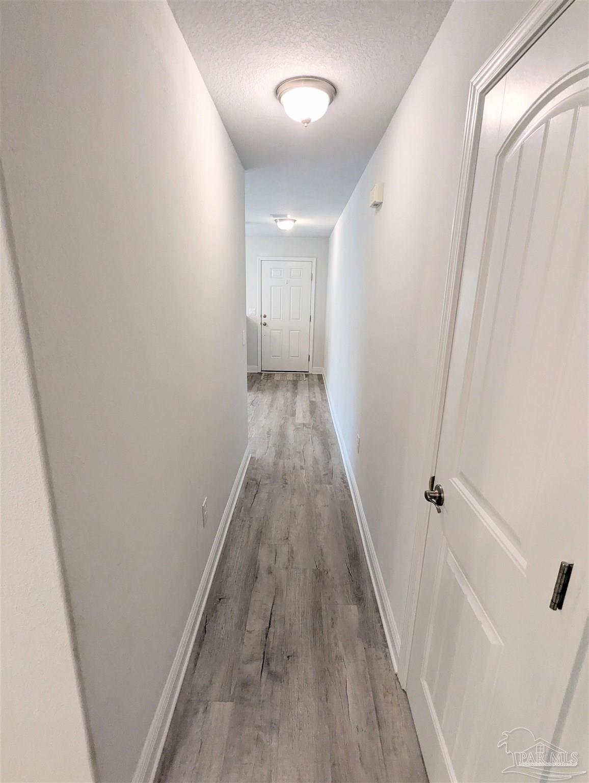 4723 Frances Street Pace, FL 32571 - Photo 5 of 41 a view of a hallway with wooden floor and staircase