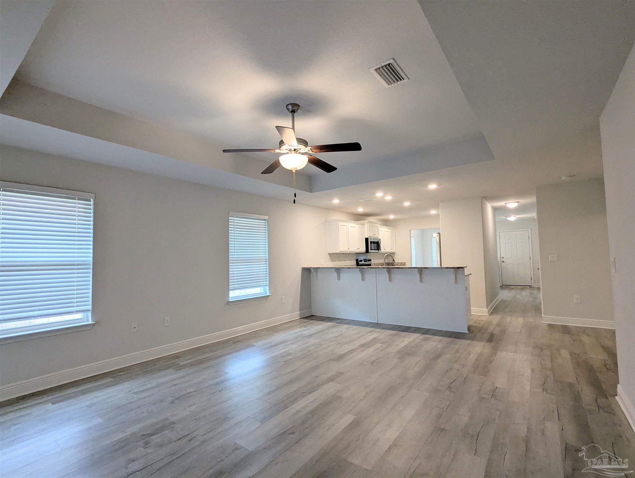 4723 Frances Street Pace, FL 32571 - Photo 8 of 41 a view of kitchen and hall with wooden floor