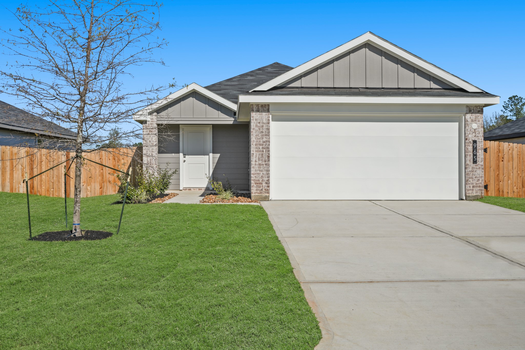 965 Sutherland Falls Street Conroe, TX 77303 - Photo 2 of 35 a front view of house with a yard and green space