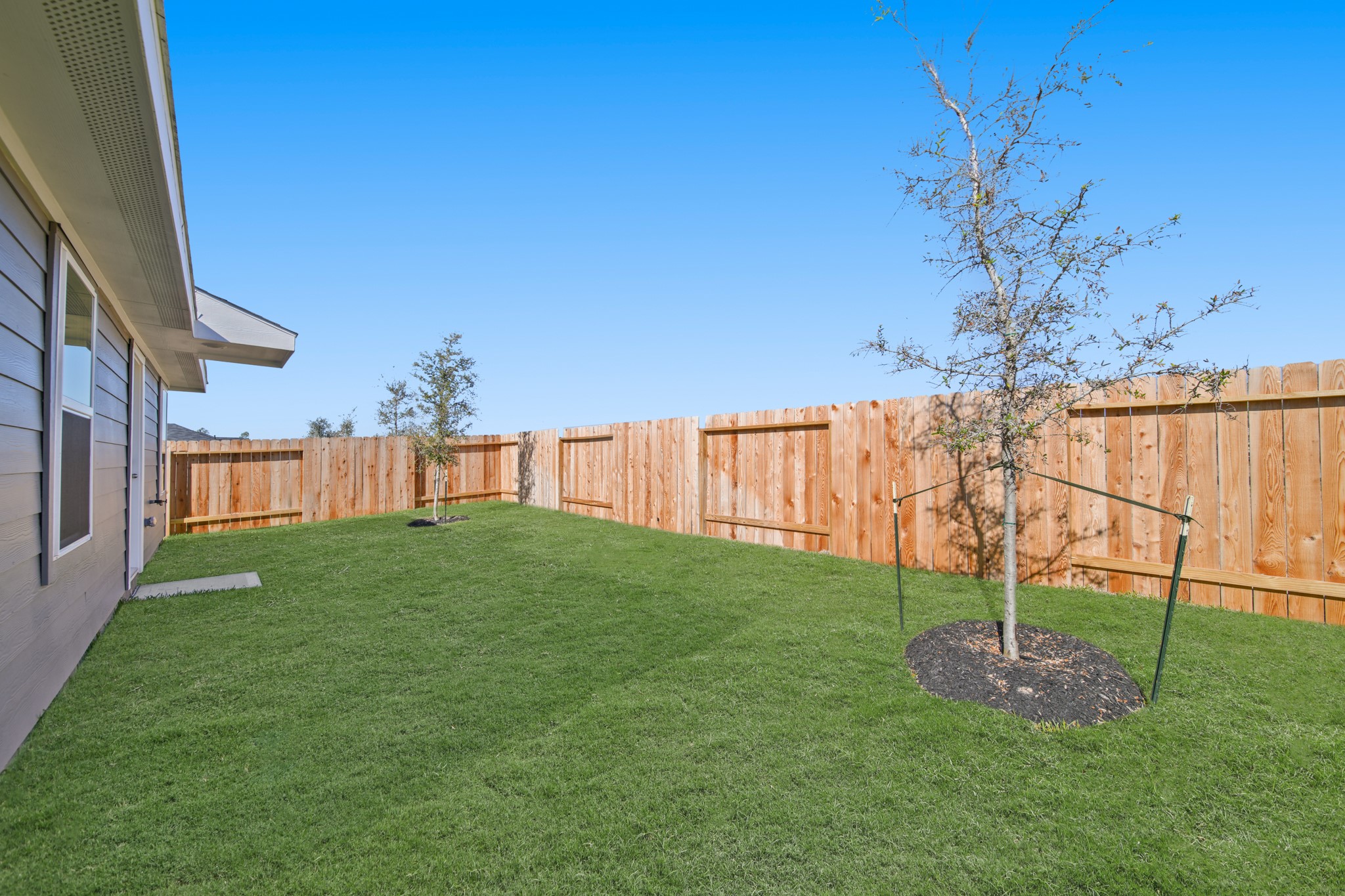 965 Sutherland Falls Street Conroe, TX 77303 - Photo 24 of 35 a view of a backyard with wooden fence