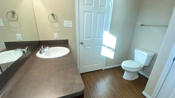 a bathroom with a toilet sink and mirror