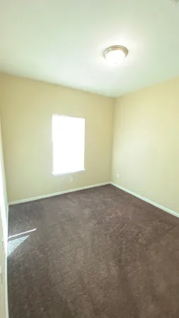 an empty room with a empty space and a window