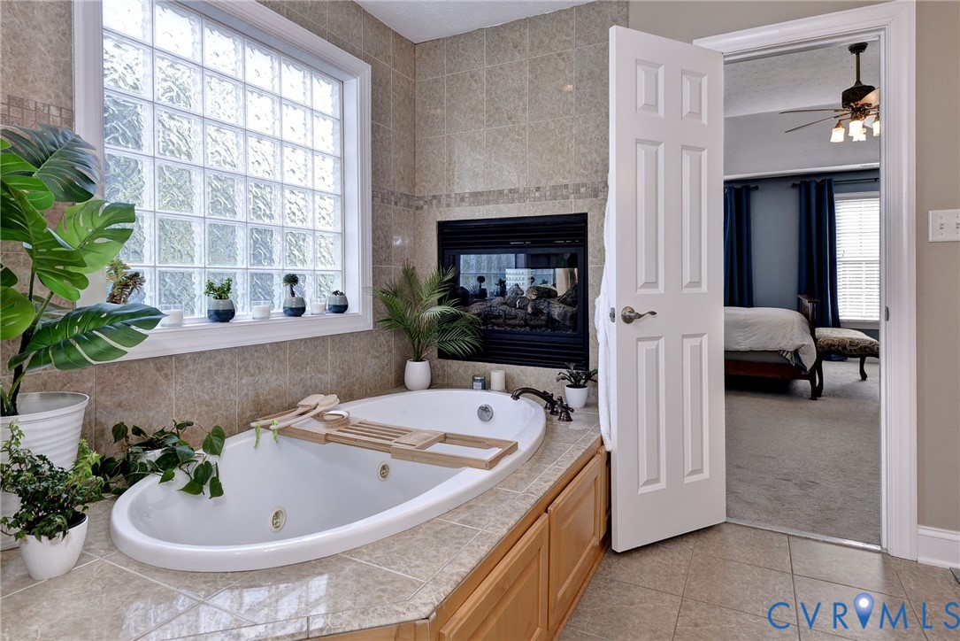 4015 Cold Spring Road Williamsburg, VA 23188 - Photo 28 of 57 Soaking tub with a tiled surround, integrated fire