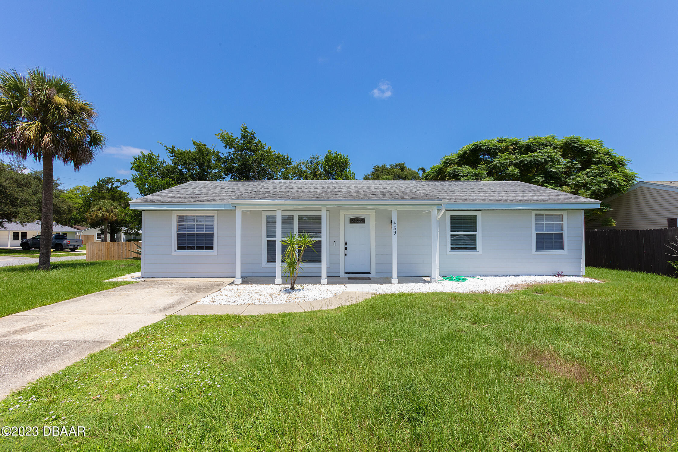 489 Wiltshire Boulevard Port Orange, FL 32127 - Photo 1 of 40 a front view of house with a garden and patio