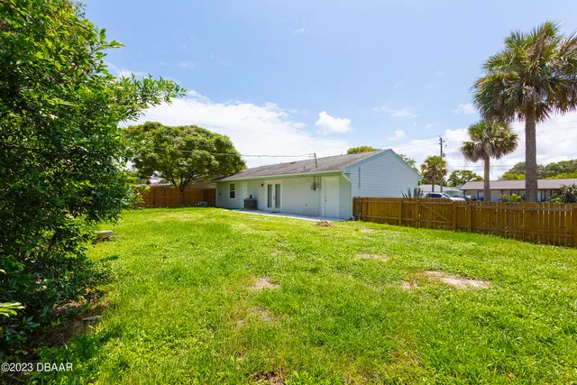 a backyard of a house with lots of green space and garden