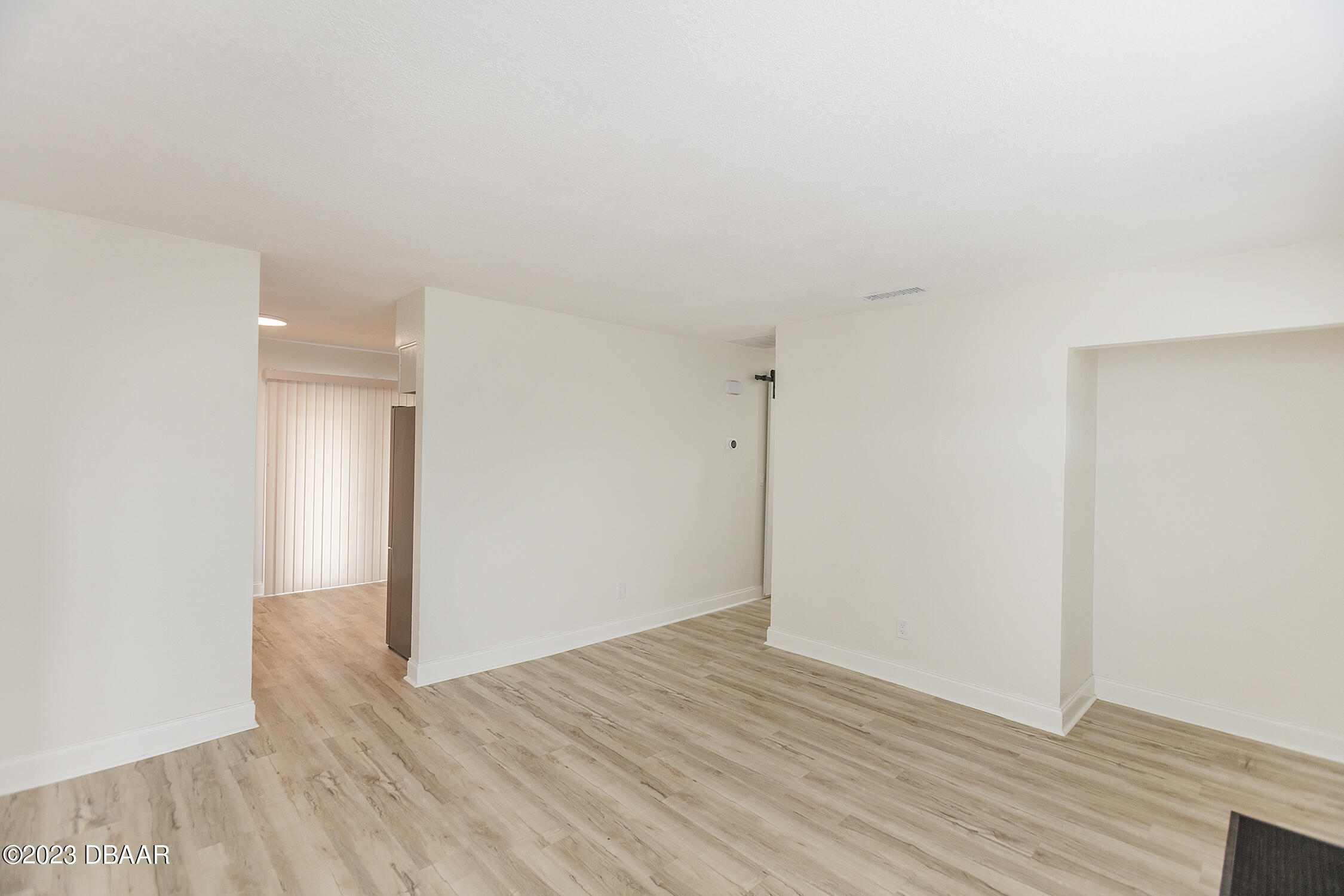 489 Wiltshire Boulevard Port Orange, FL 32127 - Photo 15 of 40 a view of an empty room with wooden floor
