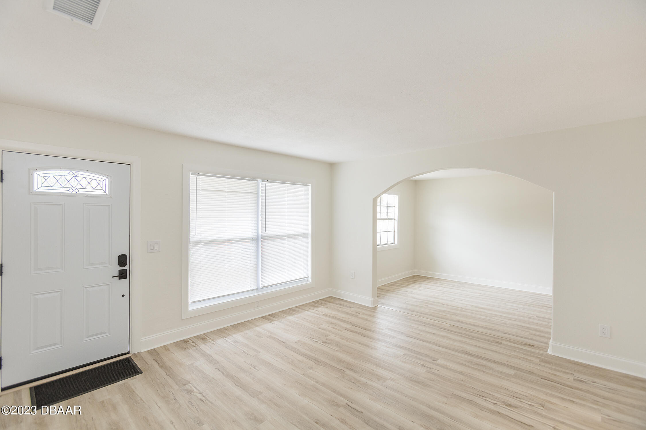 489 Wiltshire Boulevard Port Orange, FL 32127 - Photo 18 of 40 an empty room with wooden floor and windows