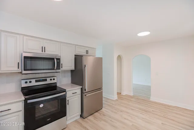 a kitchen with stainless steel appliances a refrigerator microwave and stove