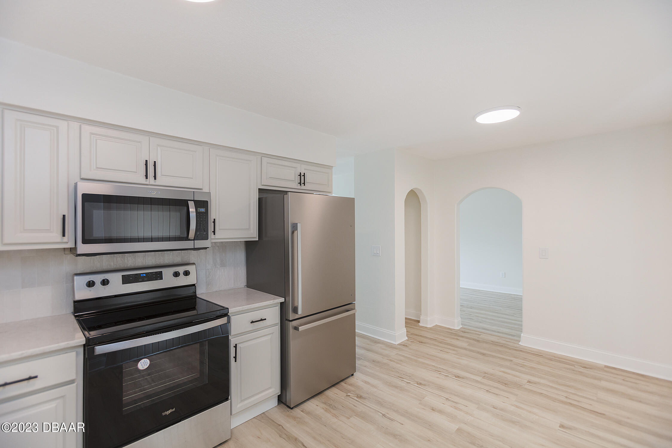 489 Wiltshire Boulevard Port Orange, FL 32127 - Photo 21 of 40 a kitchen with stainless steel appliances a refrigerator microwave and stove