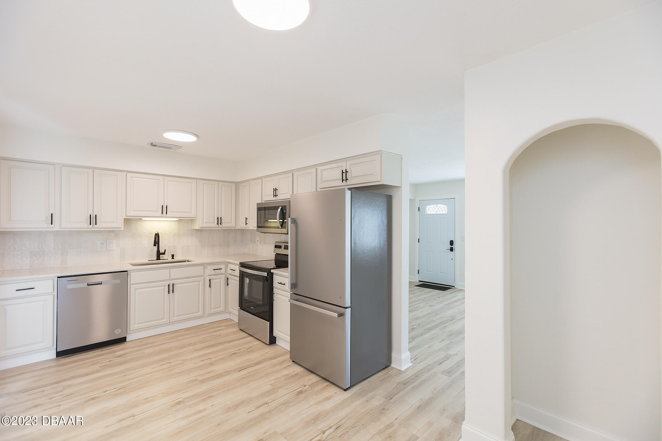 489 Wiltshire Boulevard Port Orange, FL 32127 - Photo 22 of 40 a kitchen with stainless steel appliances granite countertop a refrigerator and a stove top oven