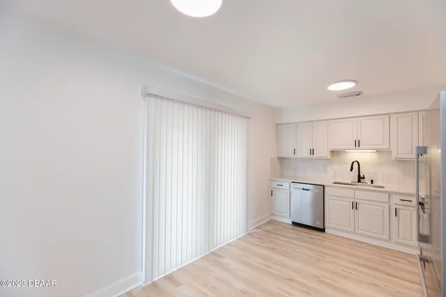 a view of a kitchen with white cabinets