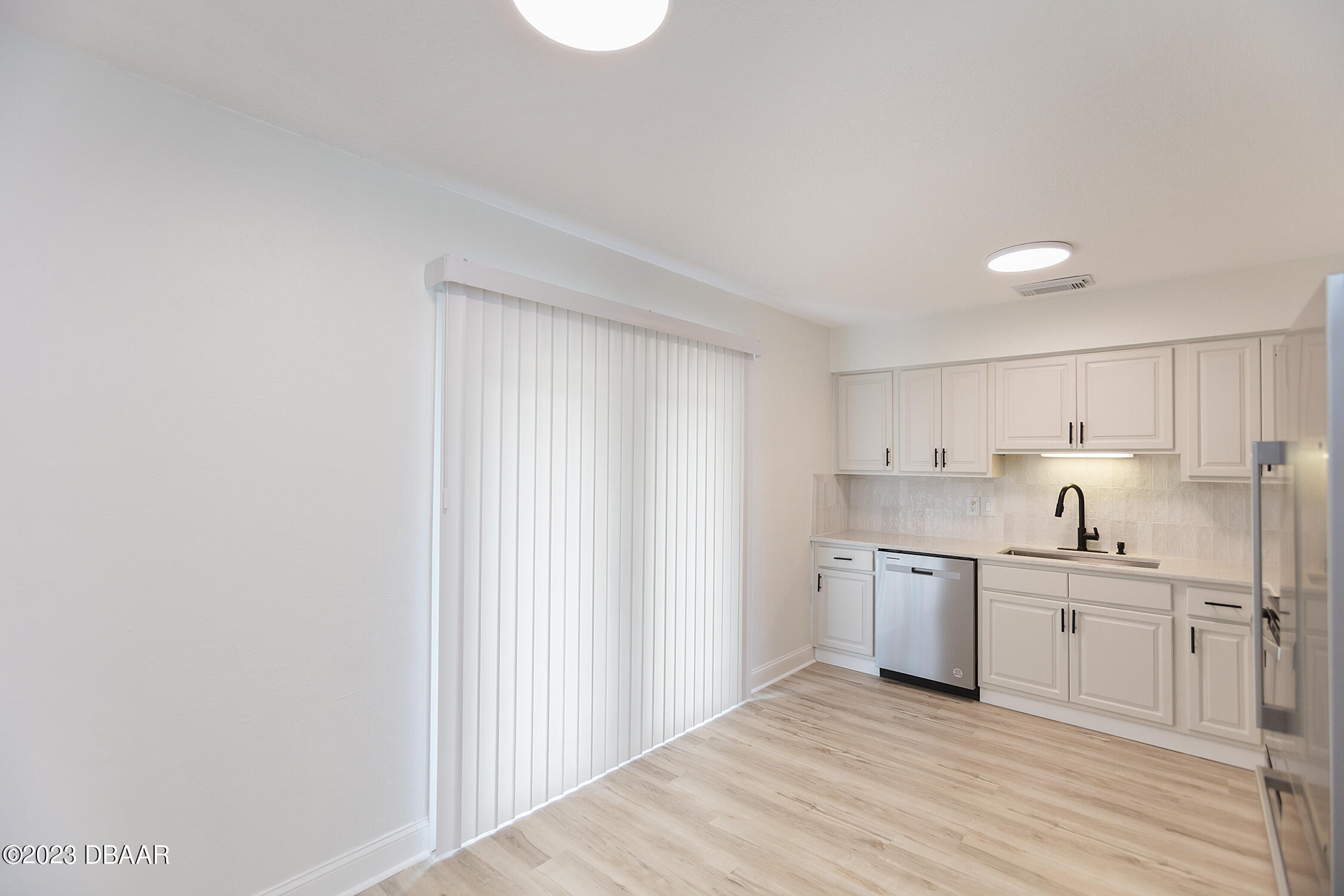 489 Wiltshire Boulevard Port Orange, FL 32127 - Photo 24 of 40 a view of a kitchen with white cabinets