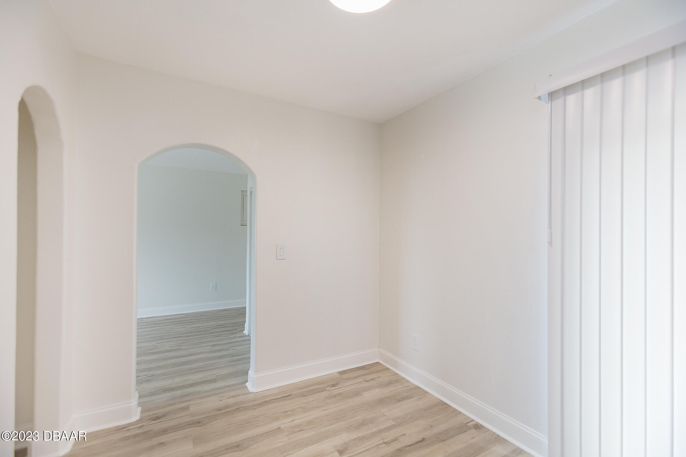489 Wiltshire Boulevard Port Orange, FL 32127 - Photo 25 of 40 a view of an empty room with wooden floor