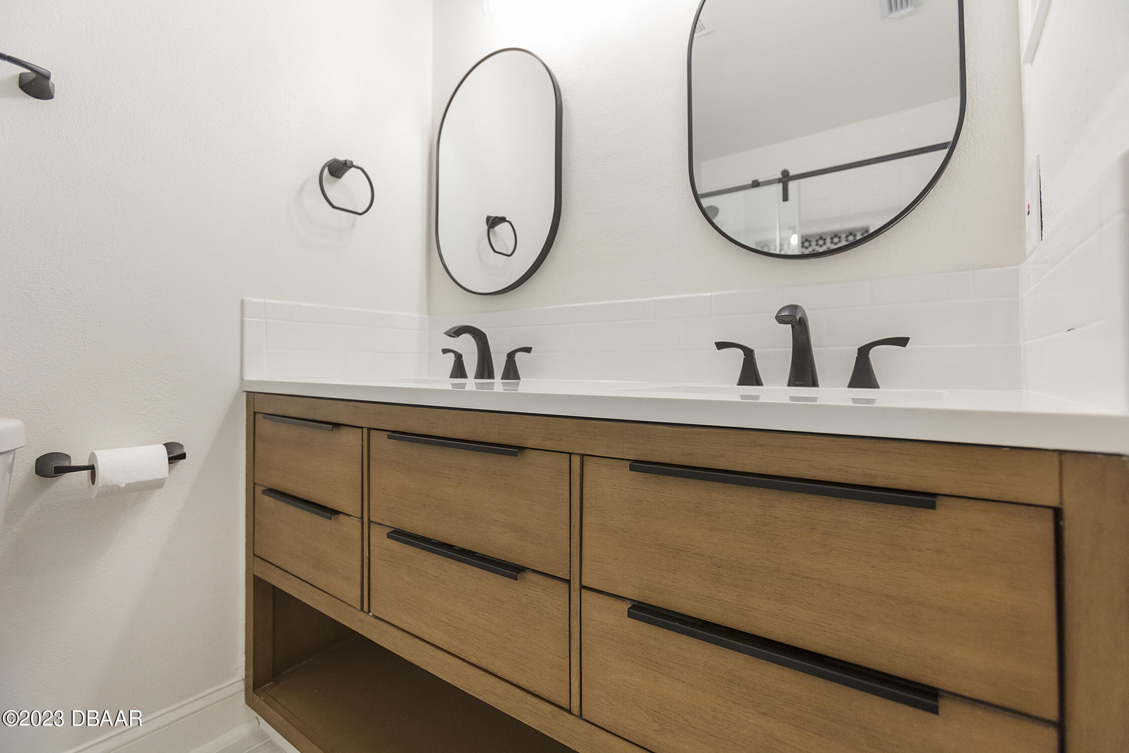 489 Wiltshire Boulevard Port Orange, FL 32127 - Photo 26 of 40 a bathroom with a sink and a mirror