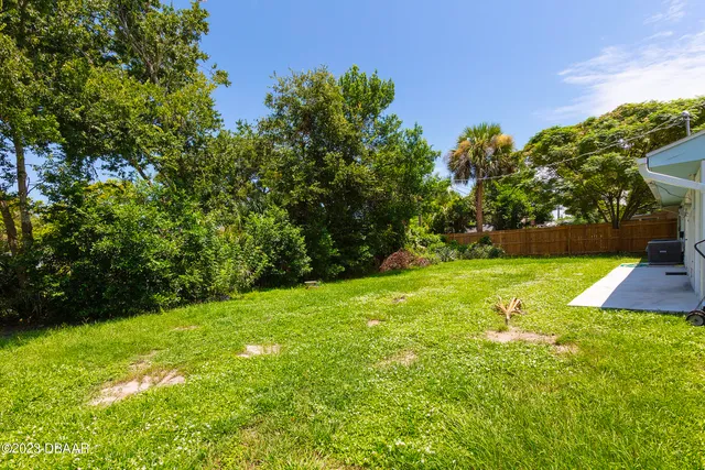 a view of yard with swimming pool and green space