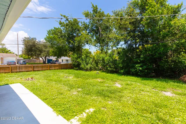 a view of yard with swimming pool outdoor seating and green space
