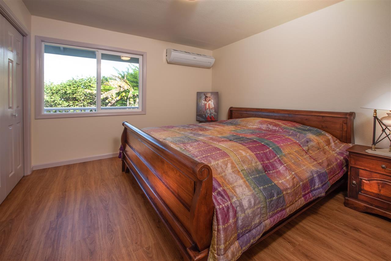 65 Door Of Faith Road Haiku, HI 96708 - Photo 13 of 30 a bedroom with a bed and wooden floor