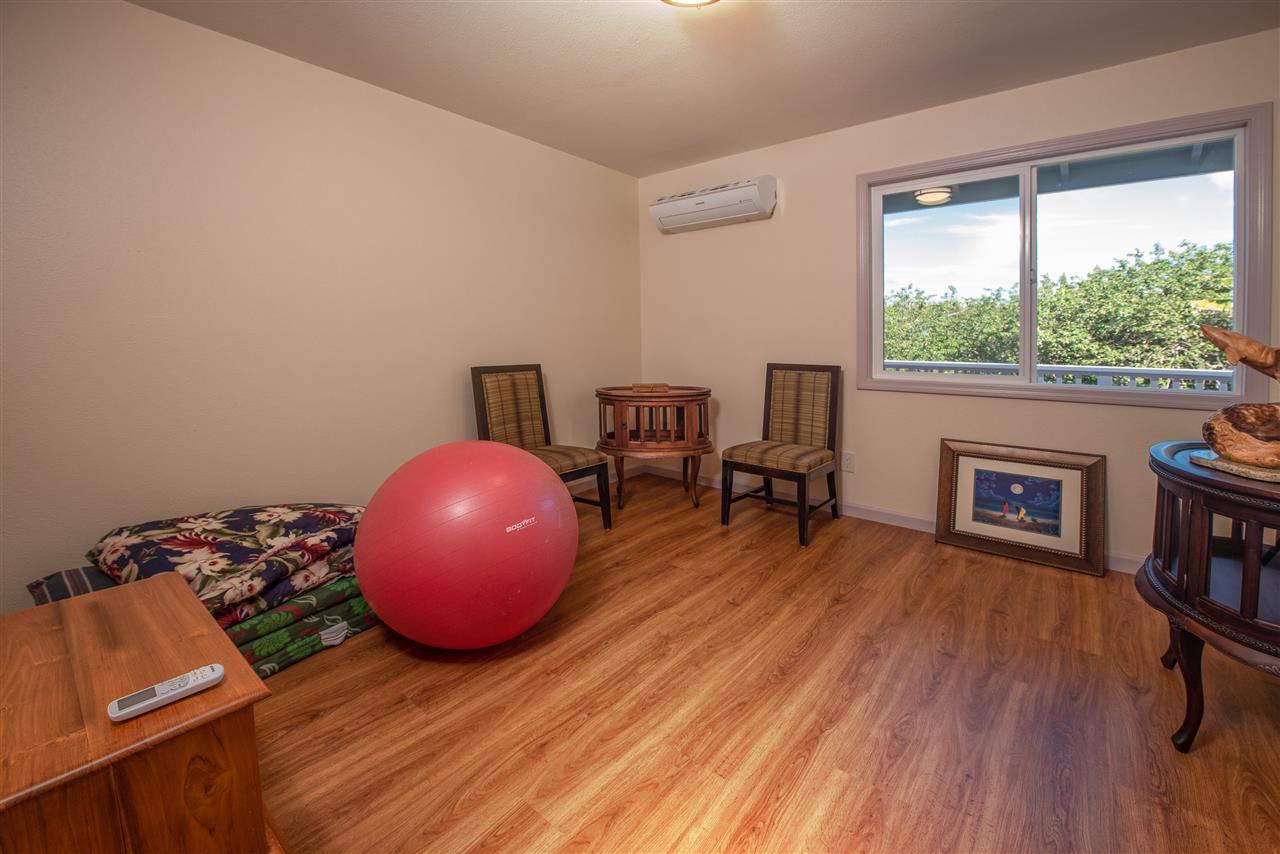 65 Door Of Faith Road Haiku, HI 96708 - Photo 14 of 30 a room with wooden floor and furniture