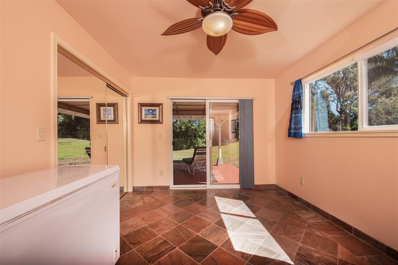 65 Door Of Faith Road Haiku, HI 96708 - Photo 22 of 30 a view of a room with a chandelier fan and windows