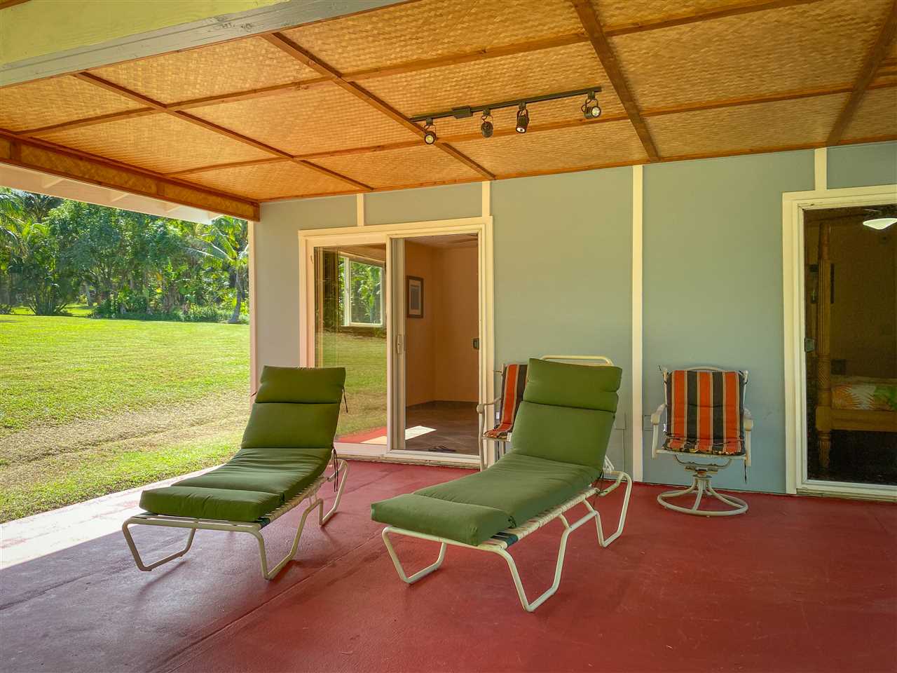 65 Door Of Faith Road Haiku, HI 96708 - Photo 26 of 30 a chair and table sitting in backyard of a house