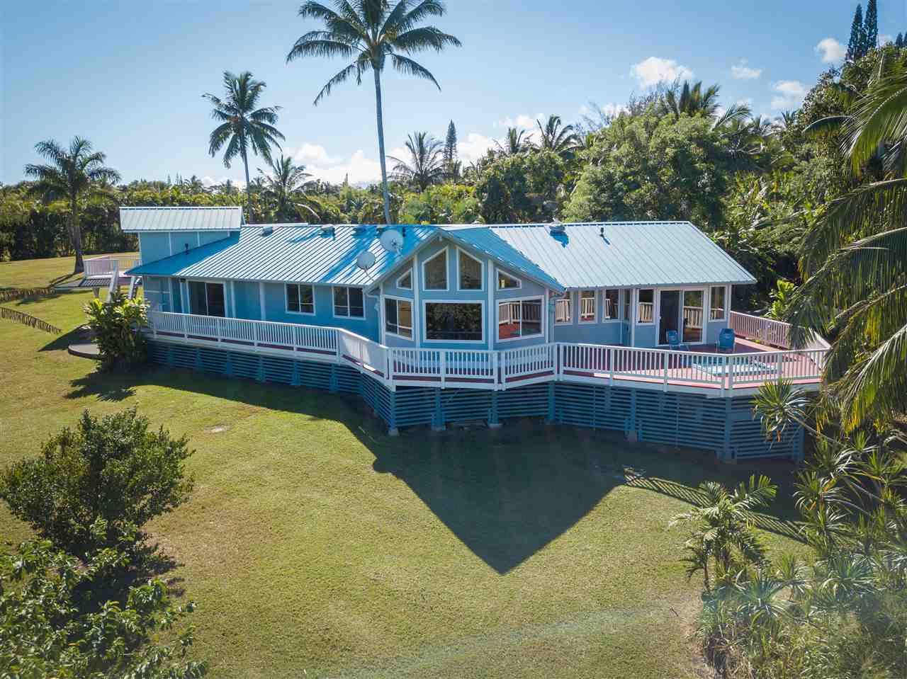 65 Door Of Faith Road Haiku, HI 96708 - Photo 4 of 30 a front view of a house with swimming pool