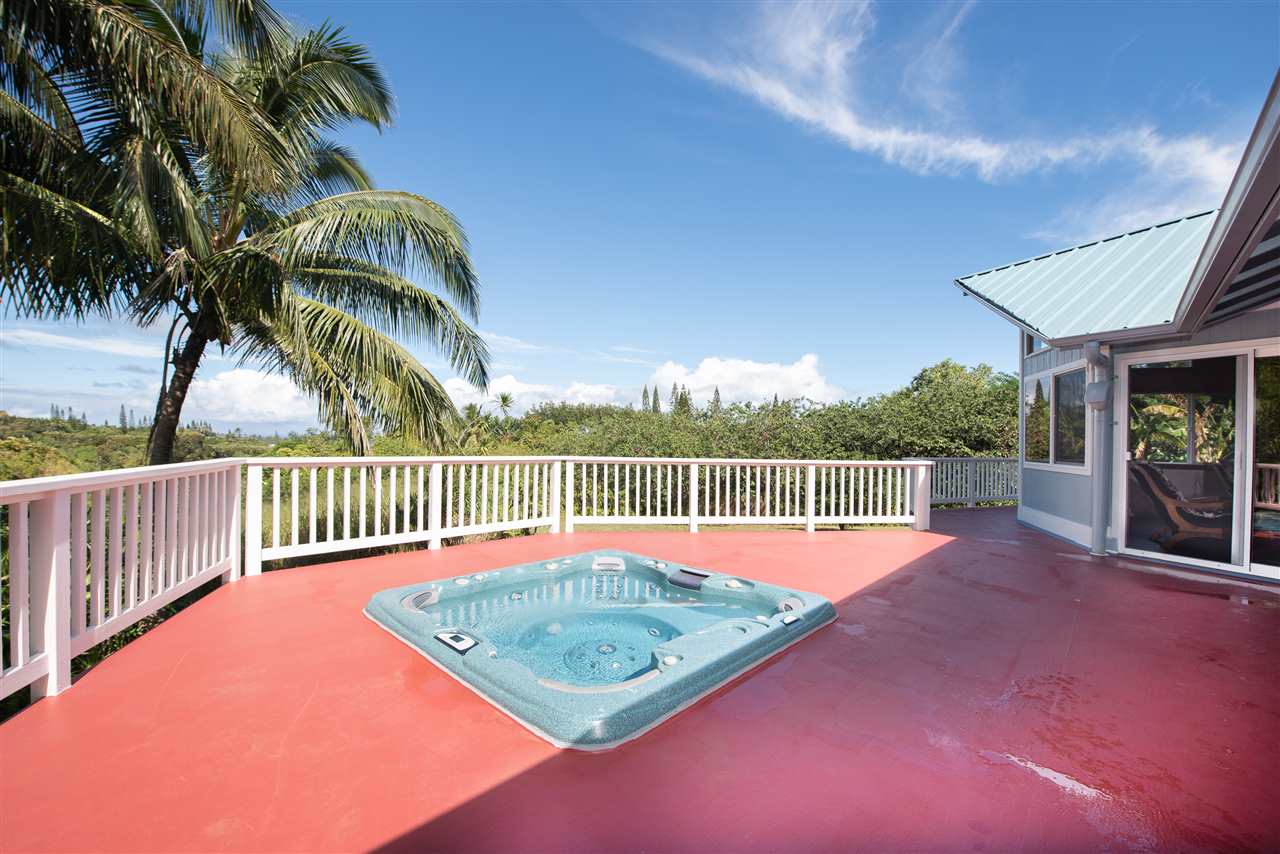 65 Door Of Faith Road Haiku, HI 96708 - Photo 7 of 30 a balcony with a table and chairs