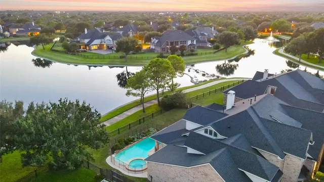 an aerial view of a house with a lake view
