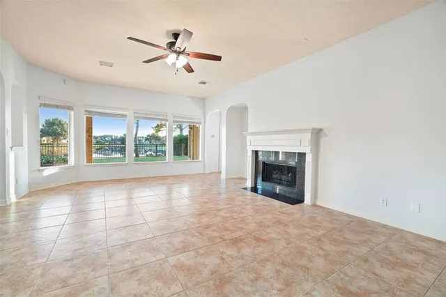 a view of an empty room with a fireplace and a large window