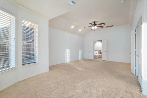 a view of a room with a ceiling fan and a window