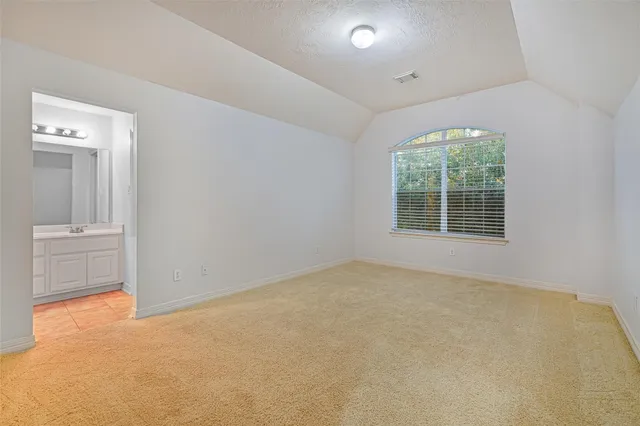 an empty room with windows and cabinet