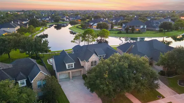 an aerial view of a house with outdoor space and a lake view