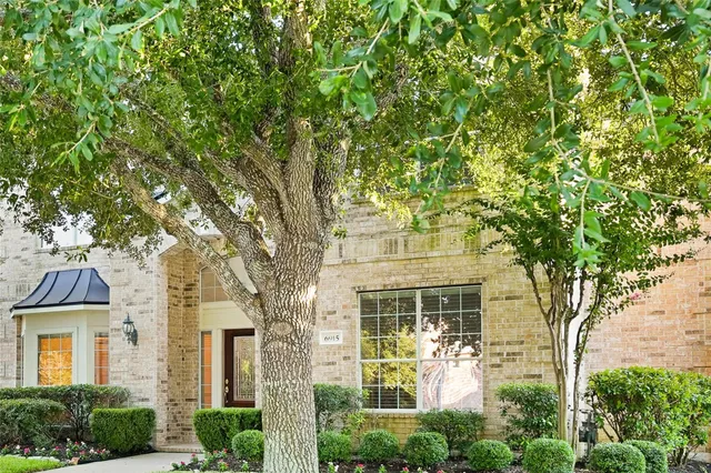 front view of a house with a tree