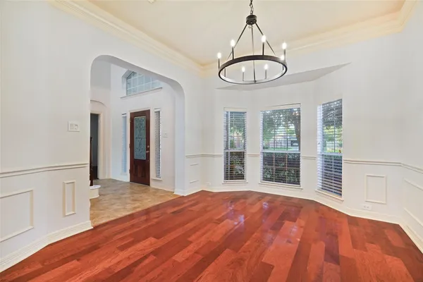 a view of a room with wooden floor and window