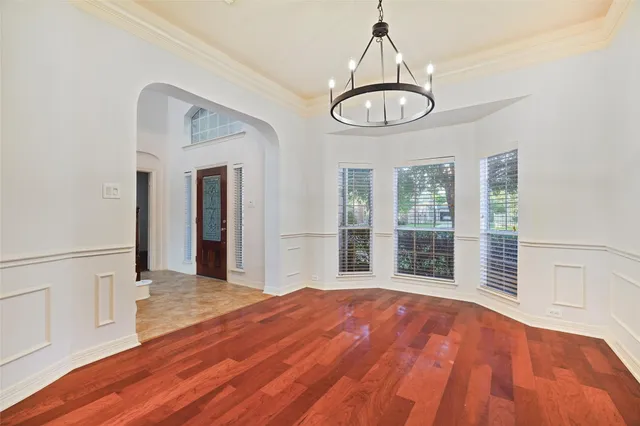a view of a room with wooden floor and window