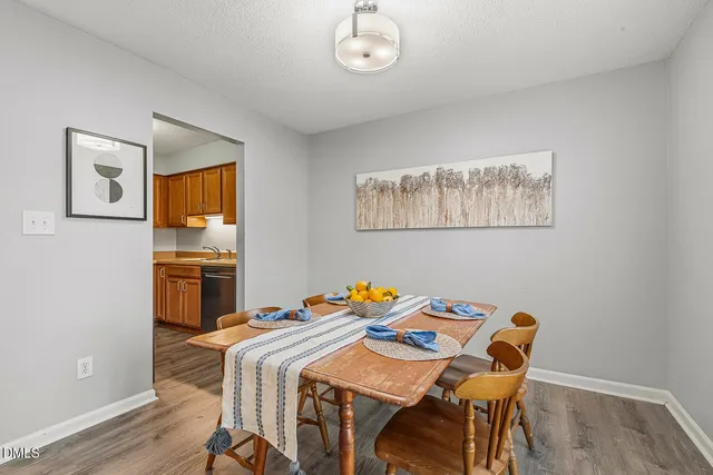 a view of a dining room with furniture and chandelier