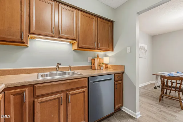 a kitchen with stainless steel appliances granite countertop a sink and cabinets
