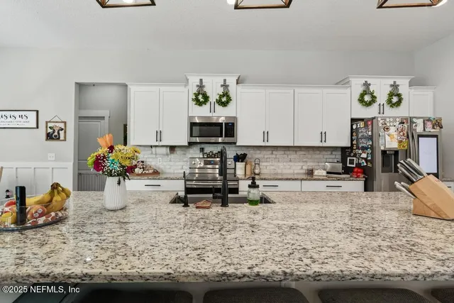 a bedroom with furniture and a flat screen tv