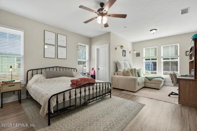 a view of a patio with a table and chairs under an umbrella